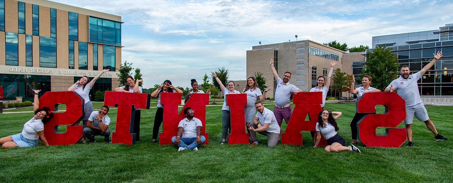 Life Coaches posing on the quad lawn.